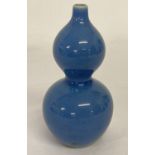 A small Chinese ceramic bottle gourd shaped bud vase with blue glaze.