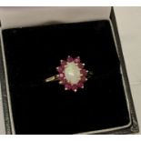 A 9ct gold opal and ruby dress ring, size N½.