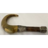 An antique horn and malacca walking cane handle with decorative hallmarked silver mounts.