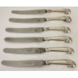 A set of six Victorian white metal pistol grip handled knives with floral decoration.