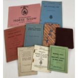 A collection of vintage military issue booklets together with a 1928 International Horse Show