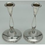 A pair of silver Mid Century candlesticks with open teardop shaped columns. Fully hallmarked Adie