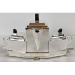 An Art Deco style 4 piece silver plated tea set. Comprising: teapot, milk jug and sugar bowl with