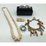 A small collection of vintage and modern costume jewellery. To include a carved bone necklace,