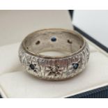 A vintage 9ct gold and silver full band ring set with small round cut blue and white sapphire