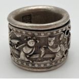 A Chinese white metal archers ring with figural detail on central rotating panel. Approx. 3cm