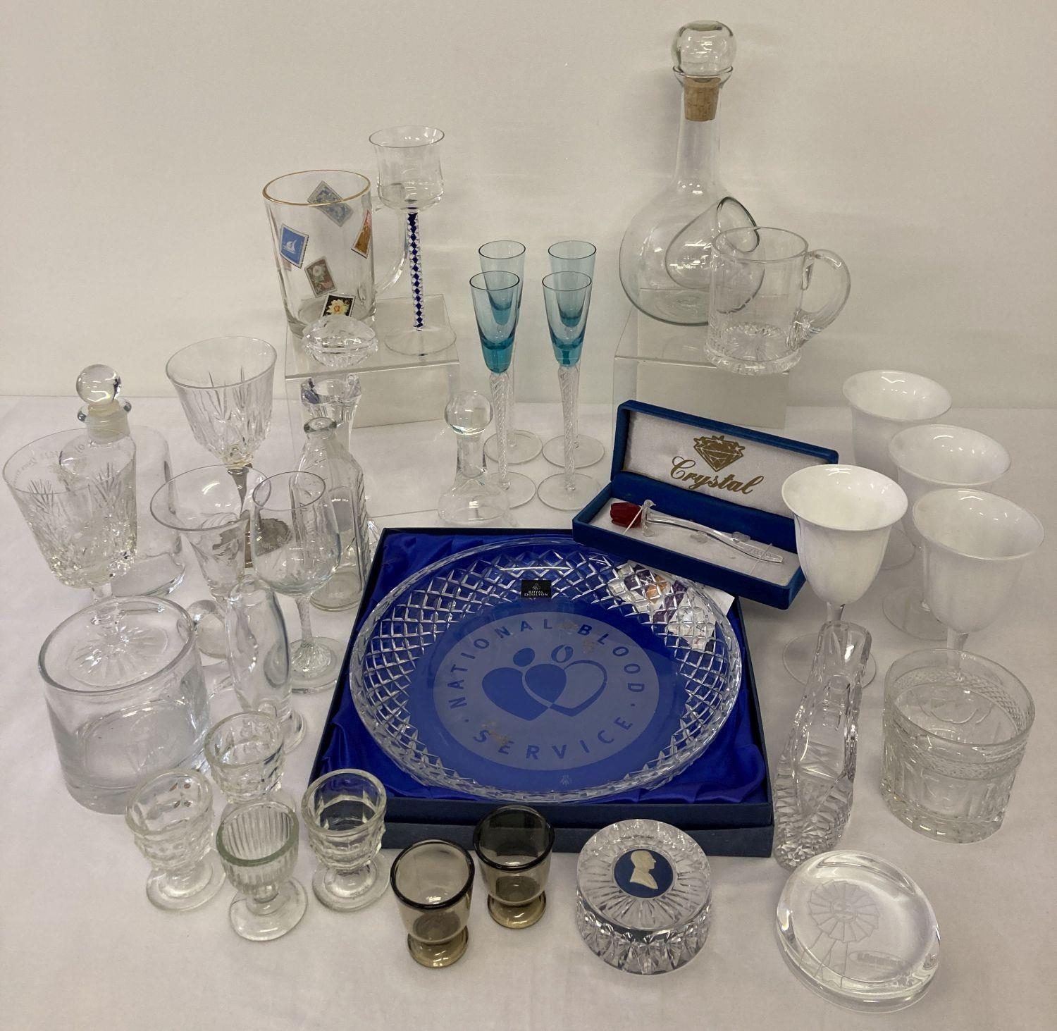 A collection of glass and crystal ware to include twist stem glasses, paperweights and vases. Lot