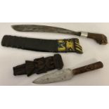 2 vintage wooden handled knives. A tribal dagger style knife with carved detail to handle and sheath
