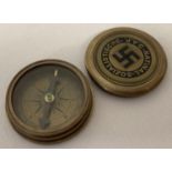 A reproduction brass cased German WWII style N.S.D.A.P compass with screw lid.