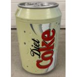 A vintage mini fridge in the shape of a Diet Coke can. Single shelf to interior.
