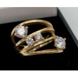 A silver gilt dress ring in a multi-ring design, set with varying sized round cut DQCZ stones by