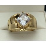 A modern design silver gilt dress ring set with a central square cut diamonique cubic zirconia stone