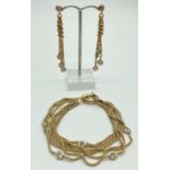 A pair of silver gilt drop style earrings together with a matching bracelet. Both are a multi strand