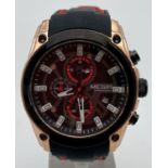 A men's chronograph wristwatch by Megir with black and red silicone strap. Gold tone and black