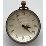 A small brass bound, desk top glass ball watch with roman numeral markers. In working order, approx.
