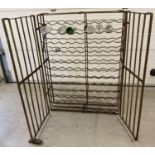 A large antique wrought iron 108 bottle wine rack cage. Two opening front cage doors with peg and