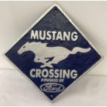 A square shaped painted cast iron wall hanging plaque for Mustang, powered by Ford. In blue and