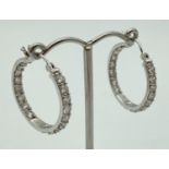 A pair of silver, clear stone set, full hoop earrings. Marked 925 to inside. Approx. 2.5cm diameter.