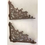 A pair of rust effect cast metal wall shelf bracelets, with decorative scroll & leaf design. Approx.