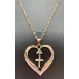A silver gilt large heart pendant with floating cross set with a small single diamond, on an 18"