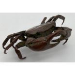A Chinese bronze figure of a crab, signed to underside. Approx. 5.5cm tall x 11cm long.