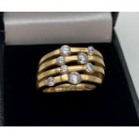 A silver gilt multi strand design dress ring set with Diamonique cubic zirconia stones in varying