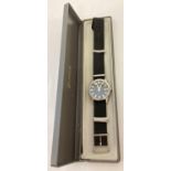 A boxed men's wrist watch by Lorus with black canvas strap. Stainless steel case with black face,