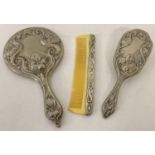 A vintage heavy silver plated 3 piece brush and mirror vanity set with decorative Art Nouveau