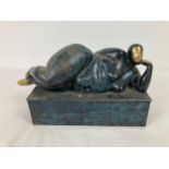 A modern hollow bronze sculptural figurine with marbled effect and gilt detail. Approx. 16cm tall