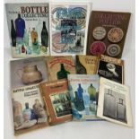 A collection of 11 vintage books relating to bottle & pot lid collecting.