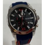 A men's chronograph wristwatch by Megir with blue and red silicone strap. Silver tone stainless