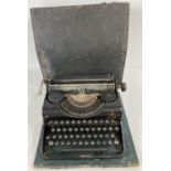 A vintage Olympia Simplex typewriter with original case.