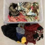 A box of mixed vintage pieces of material, some embroidered, shawls and scarves. To include chiffon,