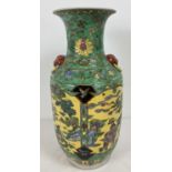 A large Chinese ceramic vase with yellow ground panelled design. Underside signed in blue, with ring
