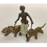A small cold painted figure of an Arab boy with 2 lions. Approx. 7cm tall x 12cm long.