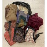 A bag of assorted vintage clothing to include waistcoats and jackets.