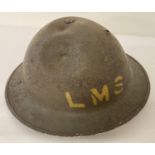 British MkII steel helmet painted khaki with stencilled 'LMS' (London Midland Scottish Railway).