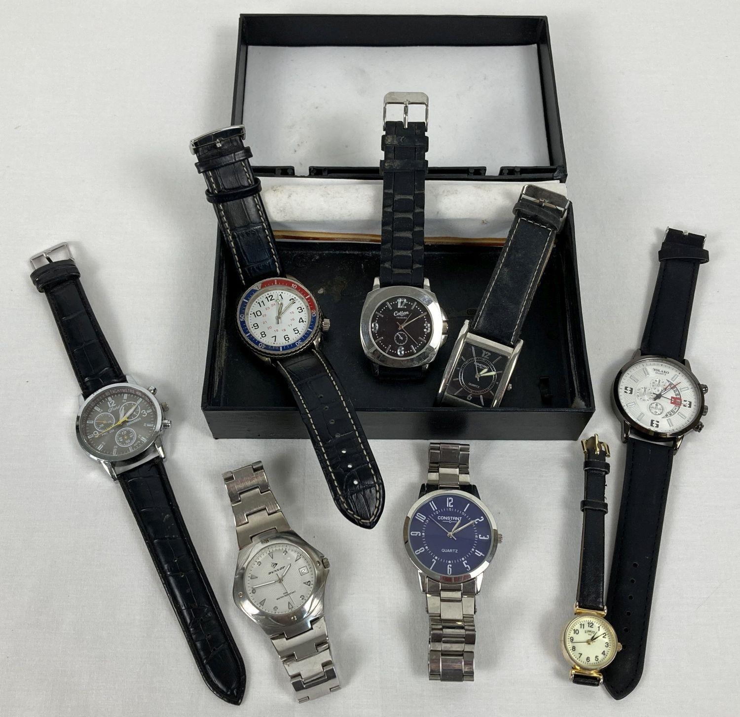 A box containing 8 men's and ladies wristwatches with both stainless steel and leather straps.