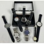 A box containing 8 men's and ladies wristwatches with both stainless steel and leather straps.