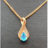 A 9ct gold drop pendant set with a teardrop cut blue topaz and 5 small round cut diamonds, on an 18"