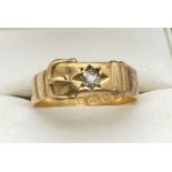 A vintage 18ct gold buckle design ring set with a single round cut 0.07ct diamond. Fully