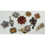 10 vintage stone set brooches in varying sizes. To include floral and sunray designs. Largest