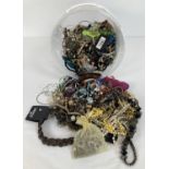 A tub of modern costume jewellery in varying conditions to include necklaces, bracelets, bangles and