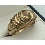 A 9ct gold dress ring set with citrine and tsavorite, by Gems TV. Central raised citrine cabochon