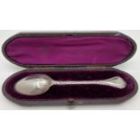 A Victorian silver tablespoon with decorative handle and original purple lined period case. Floral