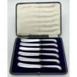 A cased set of silver pistol grip handled butter knives. All hallmarked Sheffield. One knife for C.