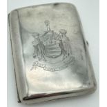 An early 20th century silver cigarette case with engraved Henderson Clan crest & motto. Front of