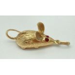 A 14ct gold mouse shaped charm/pendant set with 2 small garnets for eyes & 4 small round coral