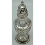 A highly decorative George III silver sugar sifter with engraved floral & scroll detail. Raised on a