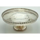 A 1920's silver bon bon dish with galleried rim and raised on a pedestal foot. Engraved to base of